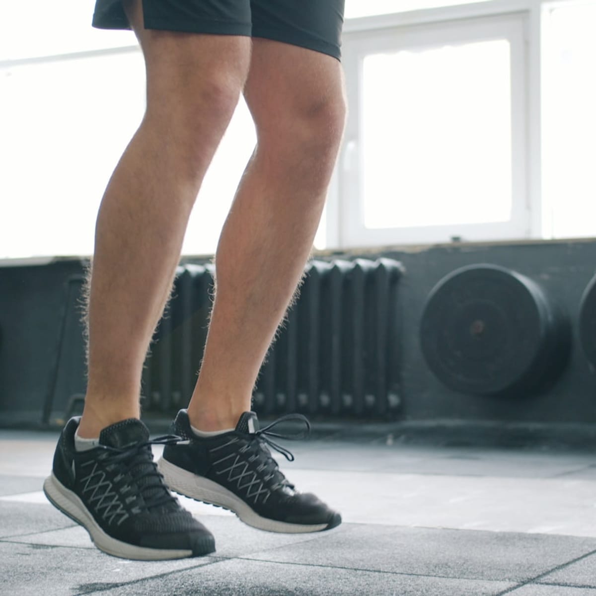 Athletic man doing jump rope cardio in a gym as part of a quick morning routine