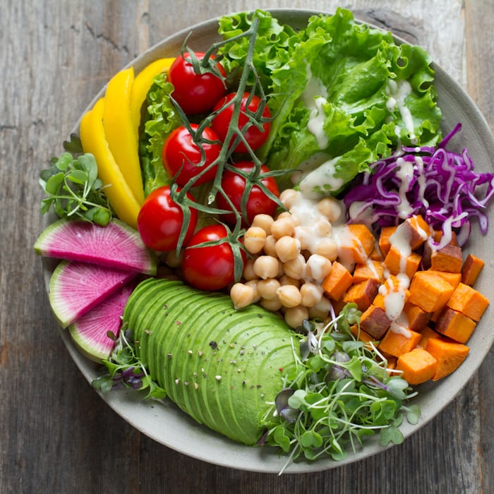 Fresh plant-forward salad and protein-rich ingredients presented in an appetizing close-up