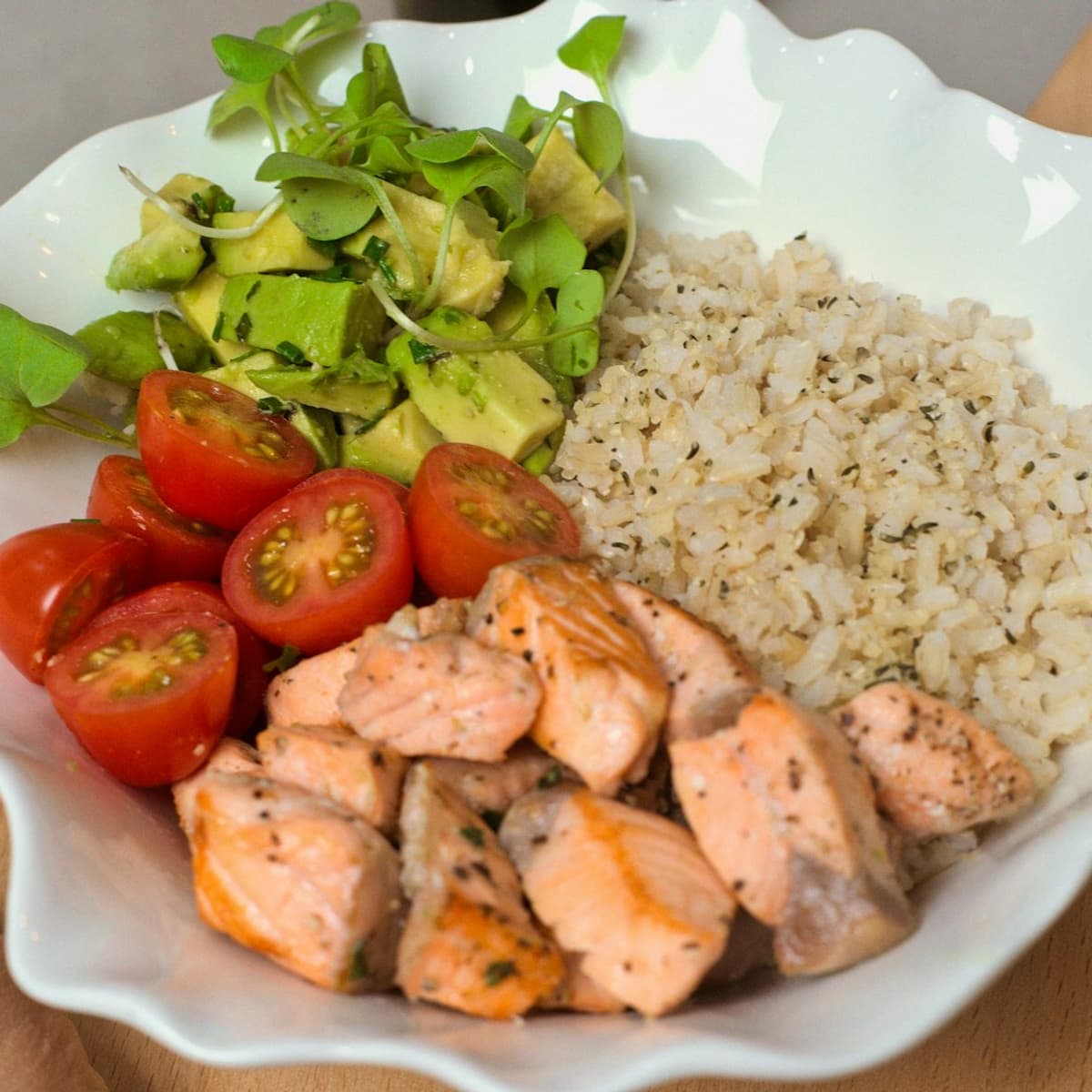 Healthy chicken rice bowl with avocado and vegetables for fitness nutrition