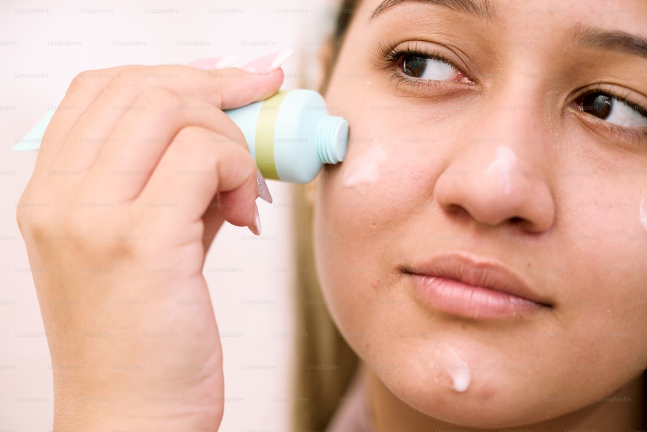Woman applying moisturizing lotion to support healthy natural skin barrier