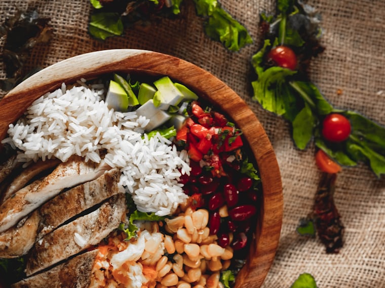 Nutritious chicken and rice bowl with beans and vegetables for digestive support