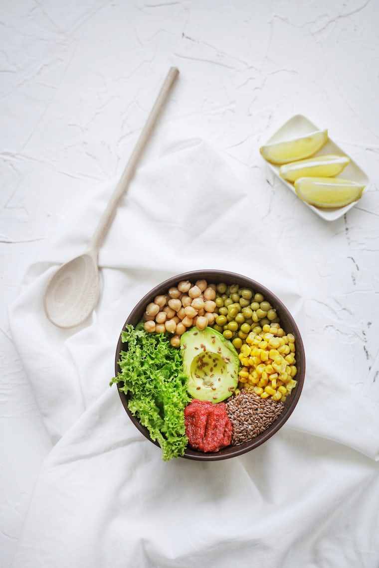 Balanced bowl of whole foods and avocado representing gut-friendly eating