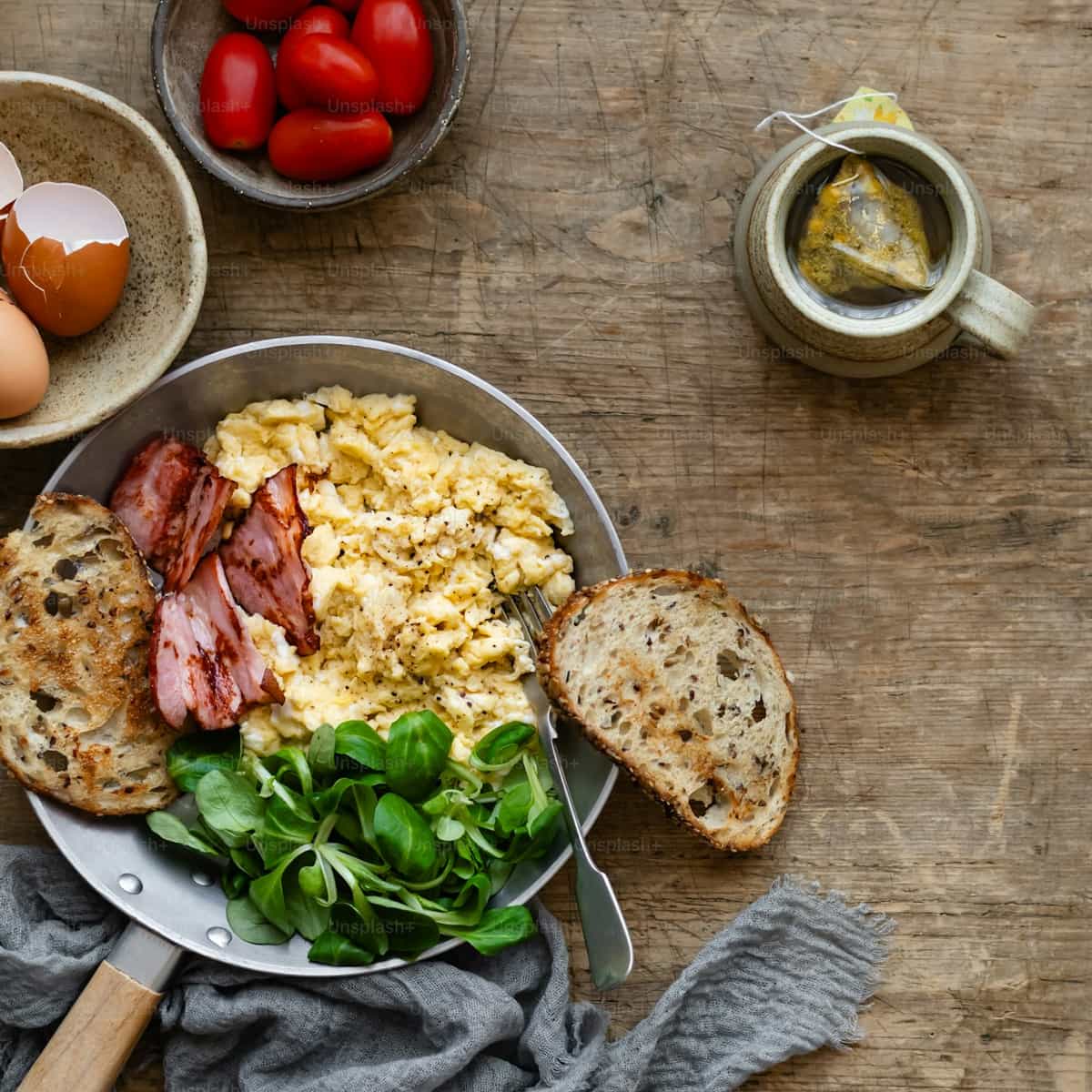 High-protein breakfast bowl with scrambled eggs, vegetables, and whole-grain toast