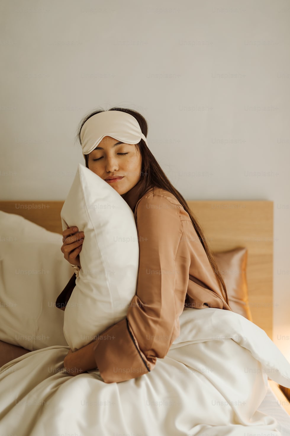Woman resting on bed to support sleep and skin recovery