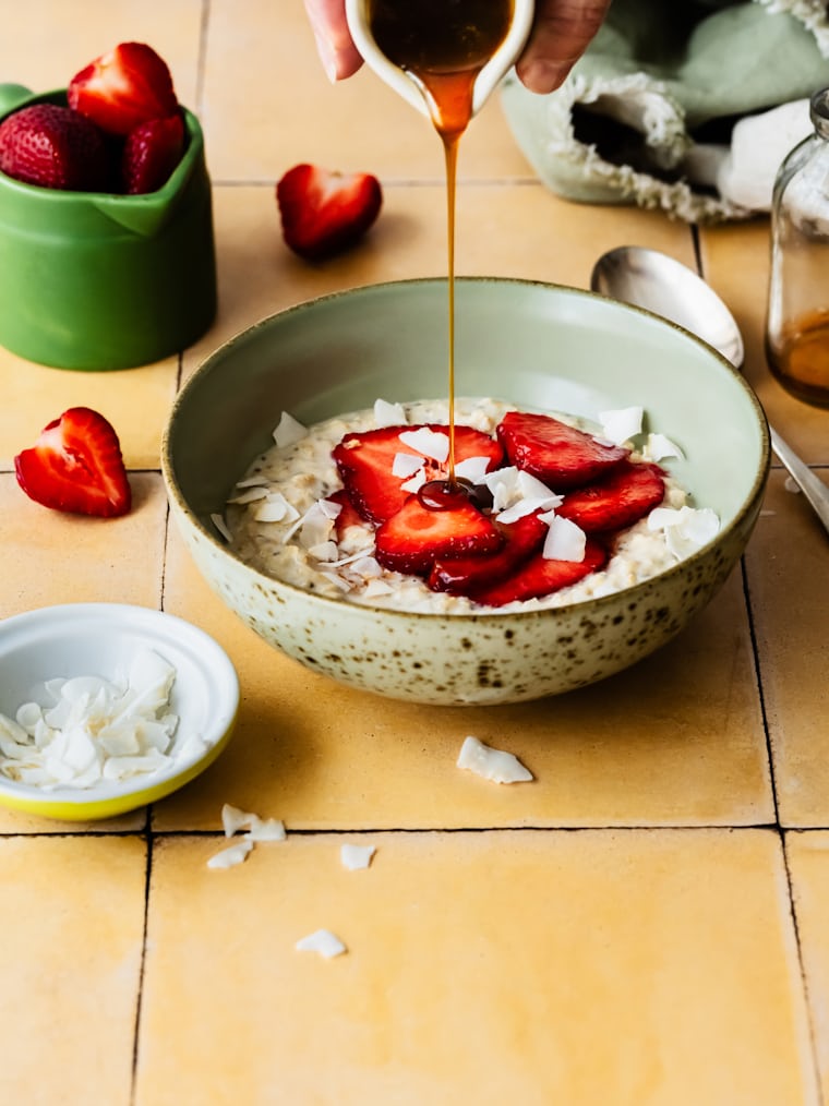 Strawberry oatmeal bowl with light drizzle showing naturally sweet dessert style