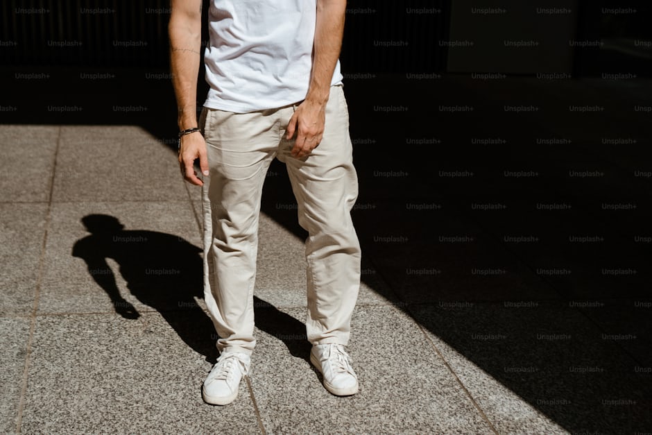 Man in clean neutral outfit demonstrating minimalist street style
