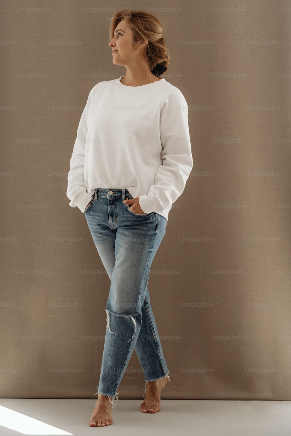 Woman in white shirt and jeans showing clean minimalist style