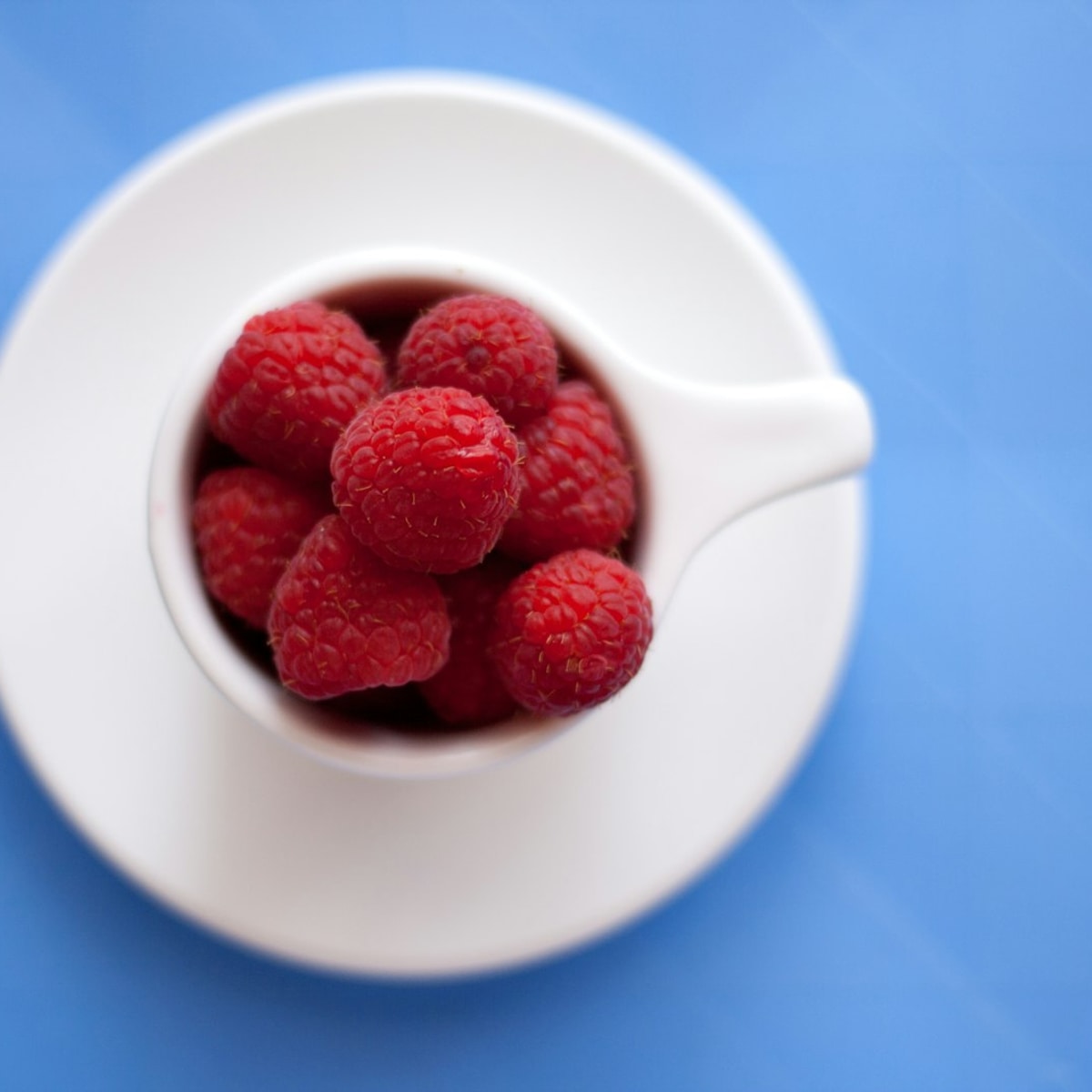 Cup of tea topped with fresh berries symbolizing calm daily stress-relief rituals