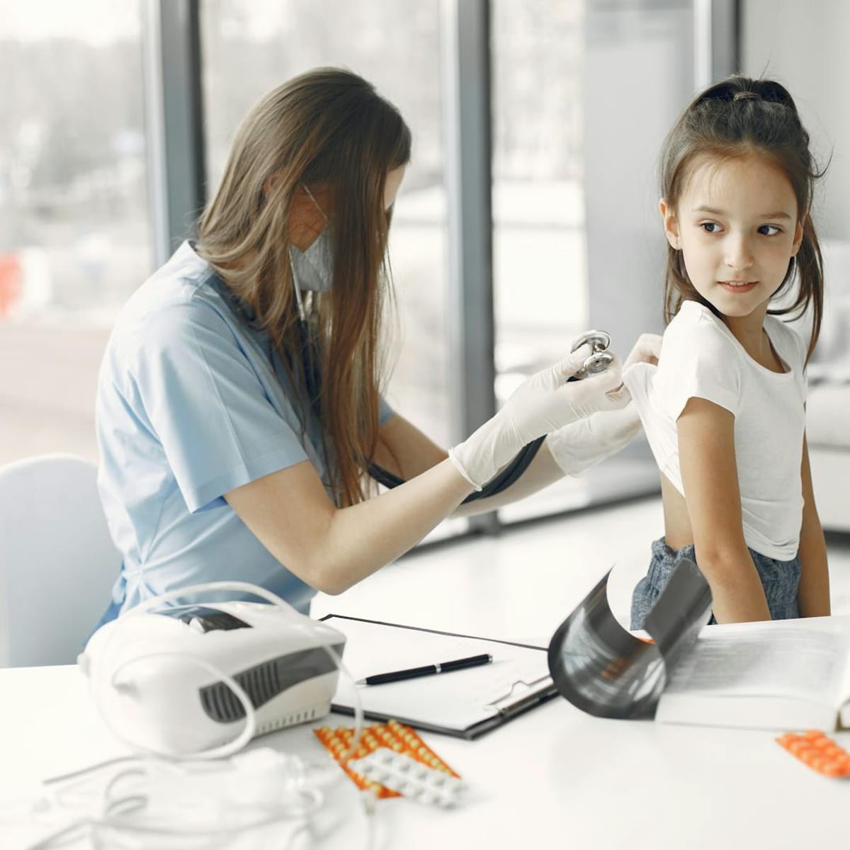 Young patient receiving a routine health screening exam at a clinic