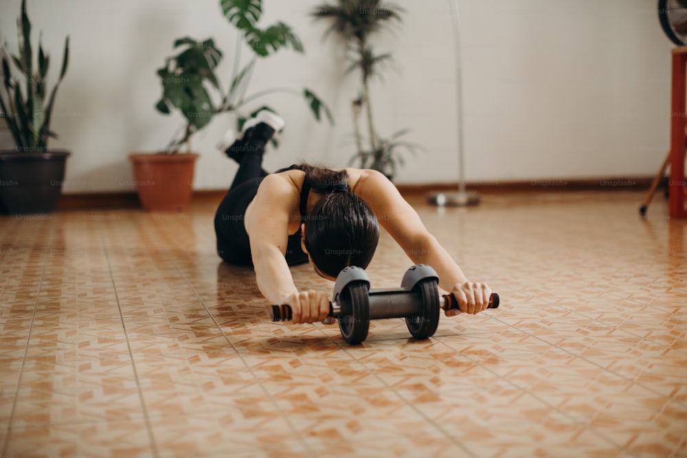 Athlete doing a push-up variation with a dumbbell in a home workout