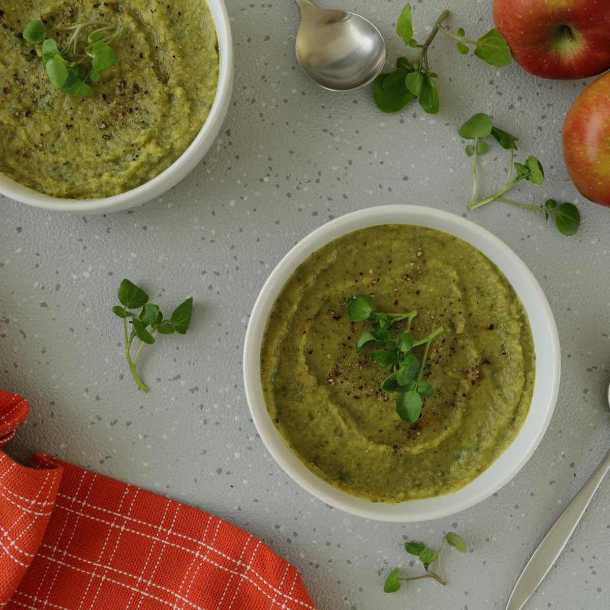 Green soup bowls with fresh ingredients representing whole-food nutrition