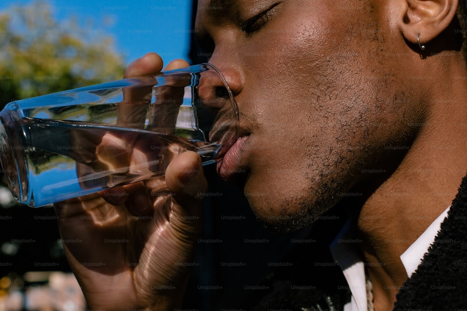 Man drinking a glass of water in close-up