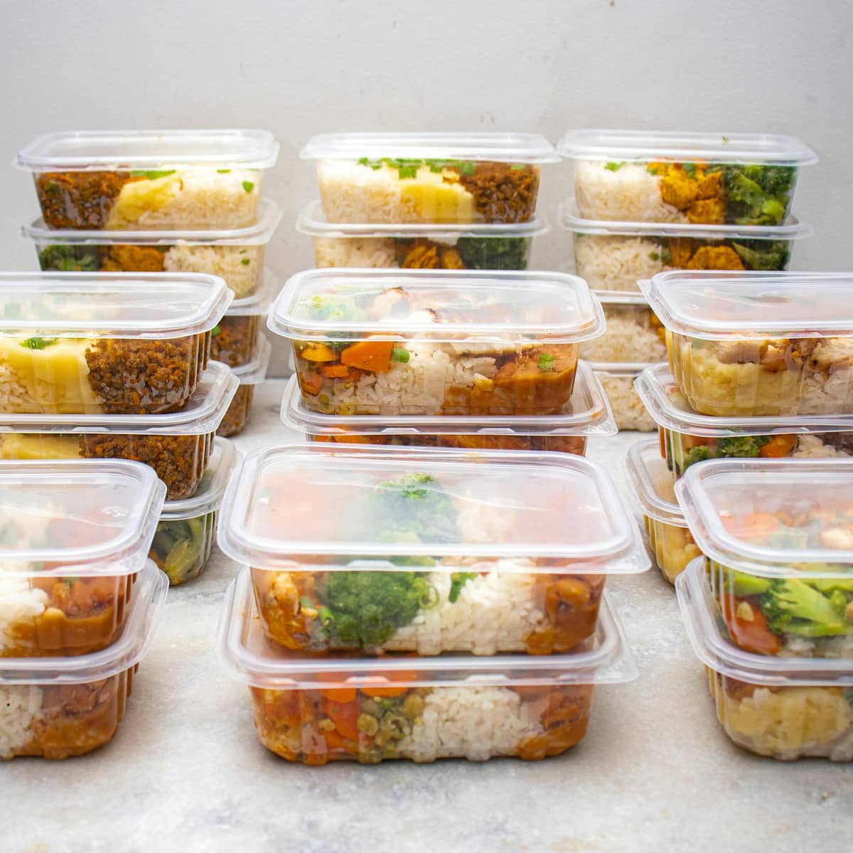 Healthy meal prep containers with rice and vegetables prepared for balanced nutrition