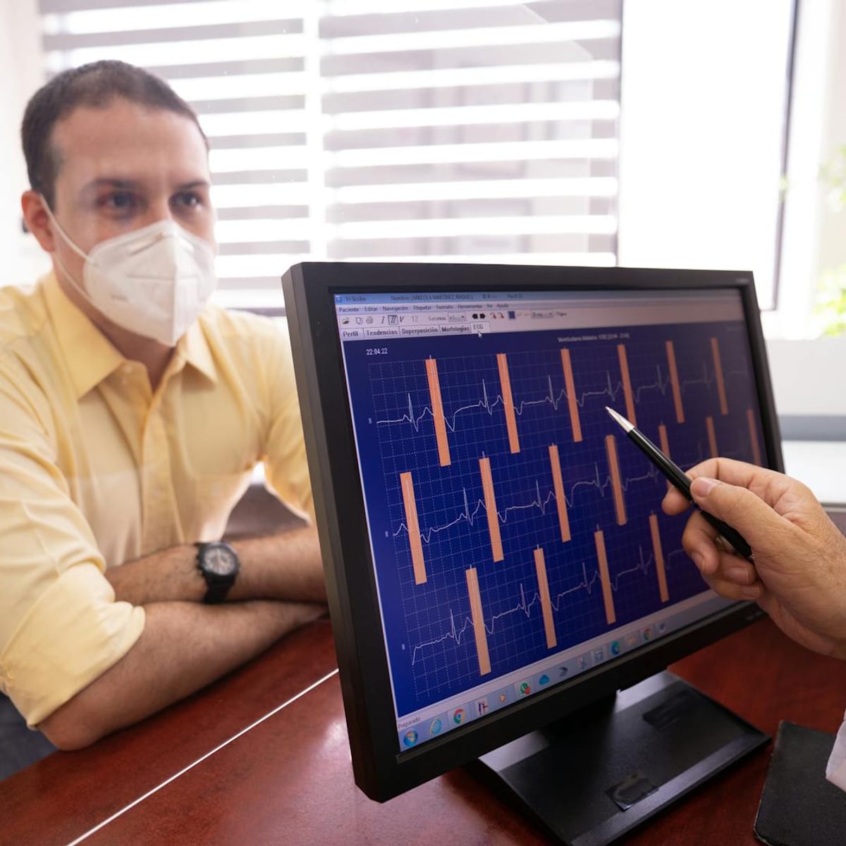 Doctor reviewing preventive health results with a young adult patient in clinic